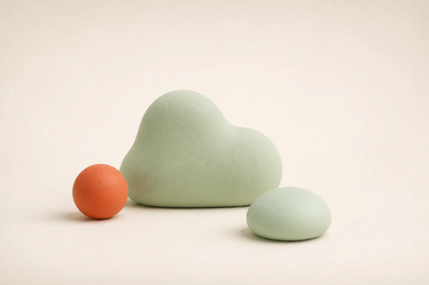 Ein ruhiger Ton-Kiesel neben einer weichen Blob-Wolke und einer kleinen Kugel als stimmungsgebendes Auflockerungs-Motiv zwischen Risikoabschnitt und Wechselpunkt.